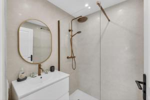 a bathroom with a shower and a sink and a mirror at 1 chambre - Ascenseur - Balcon - Proche du Palais in Cannes
