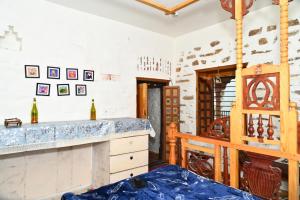 a room with a counter and a wine cellar at Tatsaaraa Kavan in Rāmgarh