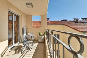 a balcony with chairs and a table on it at 1 chambre - Ascenseur - Balcon - Proche du Palais in Cannes