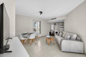 a living room with a couch and a table at 1 chambre - Ascenseur - Balcon - Proche du Palais in Cannes