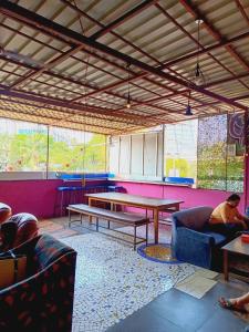 a room with couches and a ping pong table at The BVM Hostel in Mumbai
