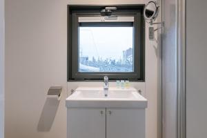 a bathroom with a sink and a window at Houseboat-Oostende in Ostend +13 photos