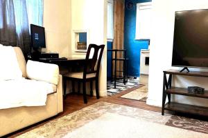 a living room with a couch and a table with a television at Economy 3 beds in Moorhead