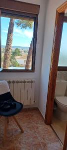 a bathroom with a toilet and a large window at Pensión San Cristóbal by Bossh! Hotels in Cuenca +52 photos