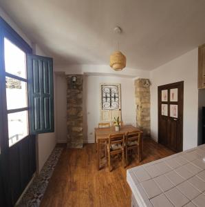 a room with a table and a dining room with a window at Cathedral Suite Jaén in Jaén