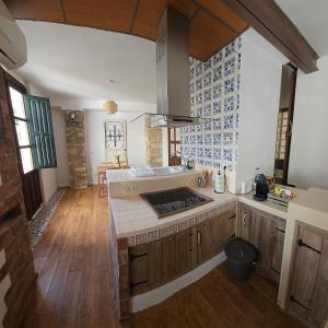 a kitchen with a stove top oven in a room at Cathedral Suite Jaén in Jaén