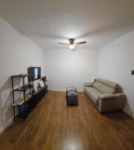 a living room with a couch and a ceiling fan at Cathedral Suite Jaén in Jaén +12 photos