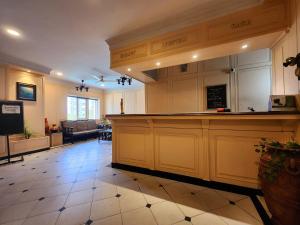 a large kitchen with a large counter in a room at Park Palace Hotel in Kolkata