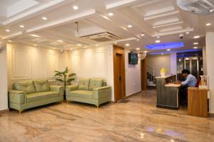 a man sitting at a counter in a lobby at Hotel Mariott Inn in Prayagraj