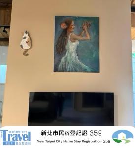 a painting of a woman hanging on a wall at Shan Cheng Guesthouse in Ruifang