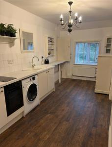 a kitchen with a washer and dryer in it at Beautiful town-flat with character - Bridge street in Hereford