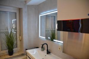 a bathroom with a sink and a mirror at Zur Eresburg in Marsberg +15 photos
