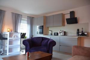 a kitchen with a couch and a chair and a table at Zur Eresburg in Marsberg