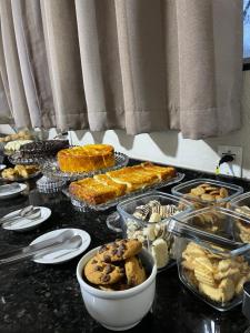 a counter top with a bunch of food on it at HOTEL SAYMON - Cafelândia PARANÁ in Cafelândia