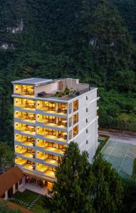 a building with yellow lights on top of it at Yangshuo Xishan Resort in Yangshuo
