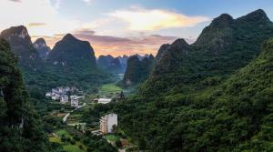 a view of a valley in the mountains at Yangshuo Xishan Resort in Yangshuo