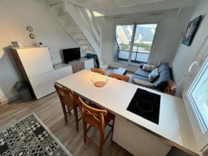 a kitchen and living room with a table and chairs at Ty Bihan plage 4p in Carnac