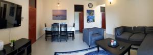 a living room with a couch and a table at Zanzi modern 2 bed apartment GF in Zanzibar City
