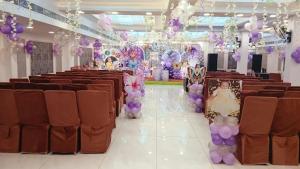 a banquet hall with brown chairs and purple decorations at Hotel SP international Lucknow in Lucknow