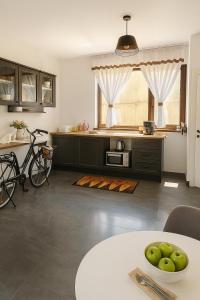 a kitchen with a bowl of apples on a table at PlaiulGreenbike in Deva
