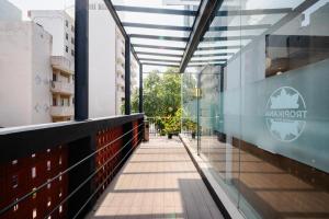 a corridor of a building with glass walls and a walkway at MK Colombo in Colombo