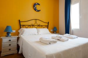 a bedroom with a bed with two towels on it at Sirius in La Isleta del Moro