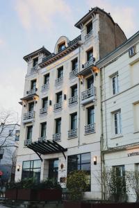 a large white building with balconies on top of it at Appartement Jehan de Beauce in Chartres