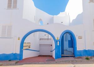 a white and blue building with a garage at Sirius in La Isleta del Moro