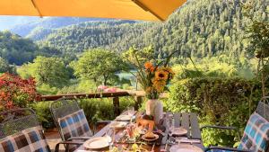 a table with a vase of flowers on top of it at Hubertus am Thumsee - Ruhe Frühstück und Alpenpanorama in Bad Reichenhall