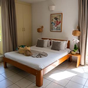 a bedroom with two beds in a room at Le Kerveguen in Saint-Gilles-les-Bains +26 photos