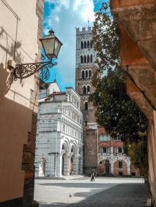 a building with a clock tower in a city at Authentic Tuscan Studio in Lucca with Private Patio in Lucca
