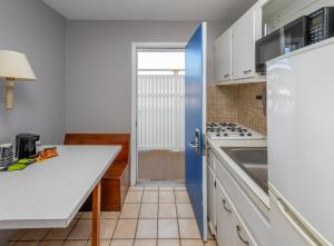 a kitchen with white cabinets and a white counter top at The Beach House at Drifting Sands in Ship Bottom