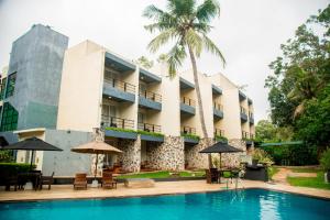 a hotel with a swimming pool in front of a building at Miridiya Lake Resort in Anuradhapura