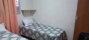 a small room with a bed and a window at Aconchego das Araras in Sirinhaém +20 photos