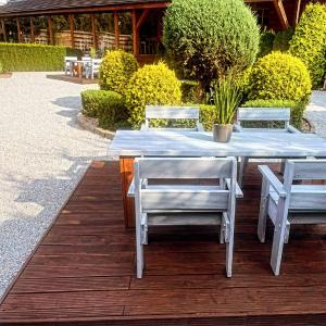 a blue table and chairs on a wooden deck at Hotel Karczma u Macieja in Bolków