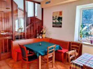 a dining room with a table and chairs at Penzion Kachlička, in Skála