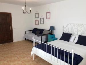 a bedroom with a bed and a couch at El aceitunal private pool in Puerto del Rosario +12 photos