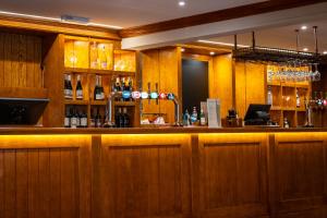 a bar with a lot of bottles of wine at The Oakwood Hotel in Gloucester