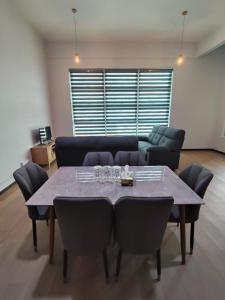 a living room with a table and a couch at Kayangan Suite - Home Studio in Kangar
