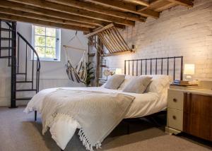 a bedroom with a large bed and a brick wall at The Freston Forge in Freston