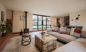 a living room with a couch and a coffee table at The Freston Forge in Freston