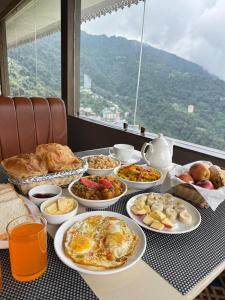a table topped with plates of food on a table at Avira Hotel in Gangtok +8 photos