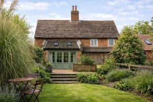 an old brick house with a green door at The Freston Forge in Freston