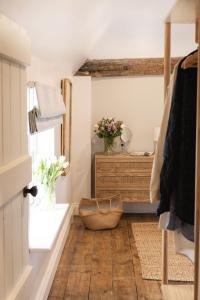 a bathroom with a wooden floor and a dresser at The Freston Forge in Freston +43 photos