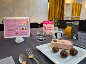 a table with a plate of food and a book at Le lieu in Saint-Amour