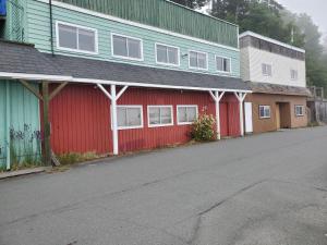 a row of buildings with red and blue at The Orca Inn in Alert Bay