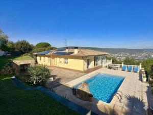 a house with a swimming pool in front of a house at Villa Aura en Platja d'Aro in Platja d'Aro