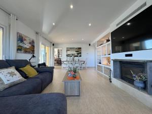 a living room with a couch and a fireplace at Villa Aura en Platja d'Aro in Platja d'Aro
