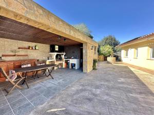 an outdoor patio with a table and a kitchen at Villa Aura en Platja d'Aro in Platja d'Aro