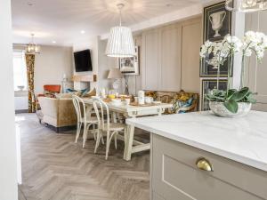 a kitchen and living room with a table and chairs at 2 Llewelyn Street in Conwy